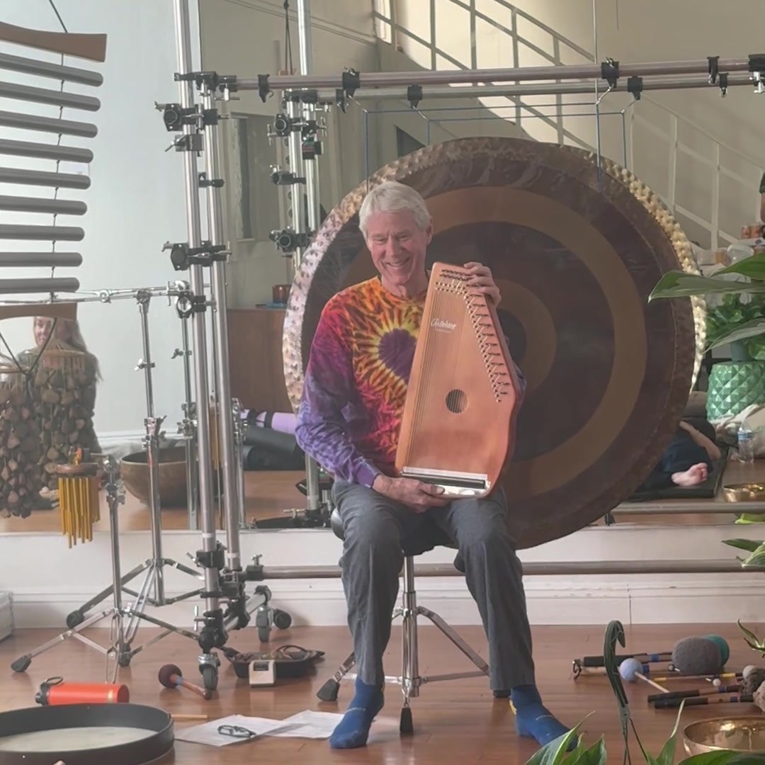 Swirl of Sound playing a monochord in front of the gong at IS/BE Outpost